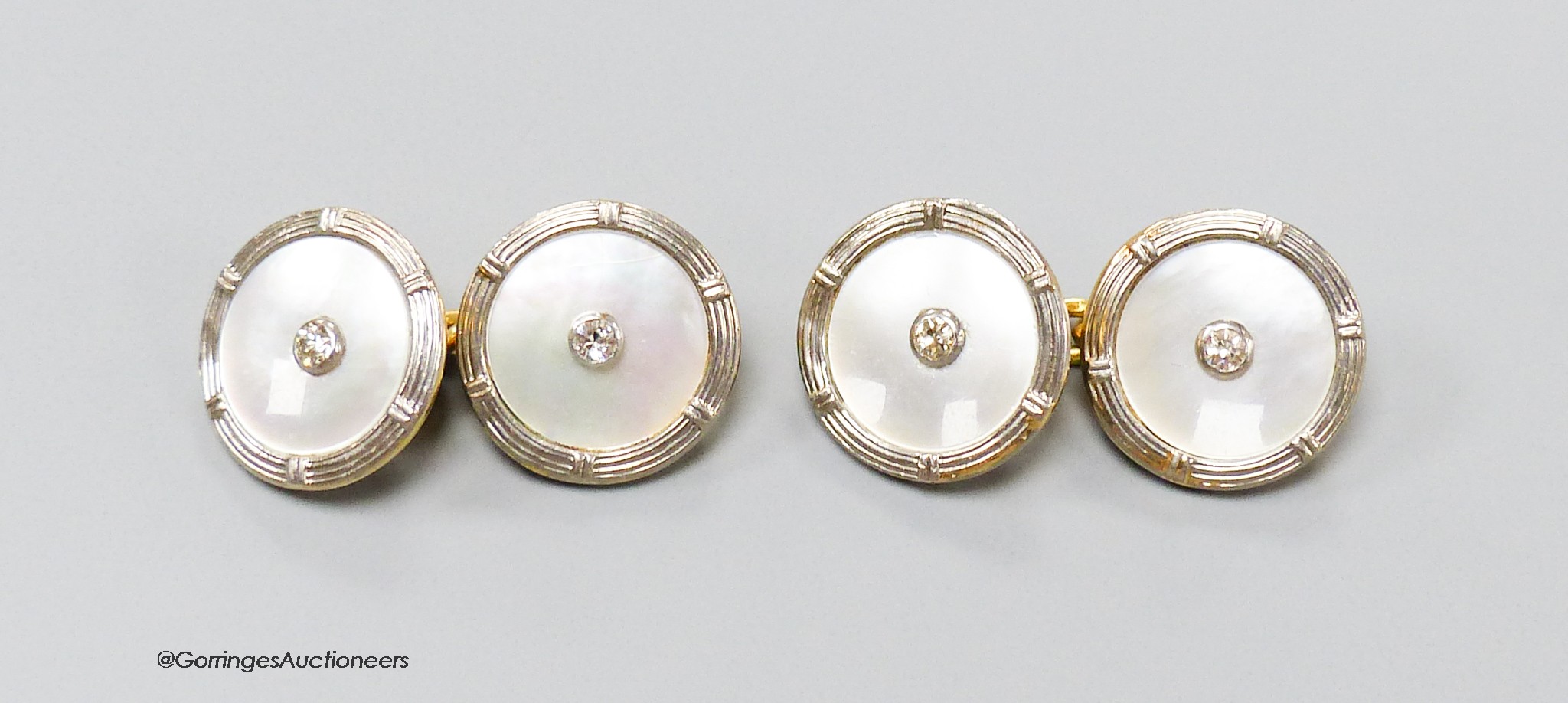 A pair of 18ct, mother of pearl and diamond set disc cufflinks